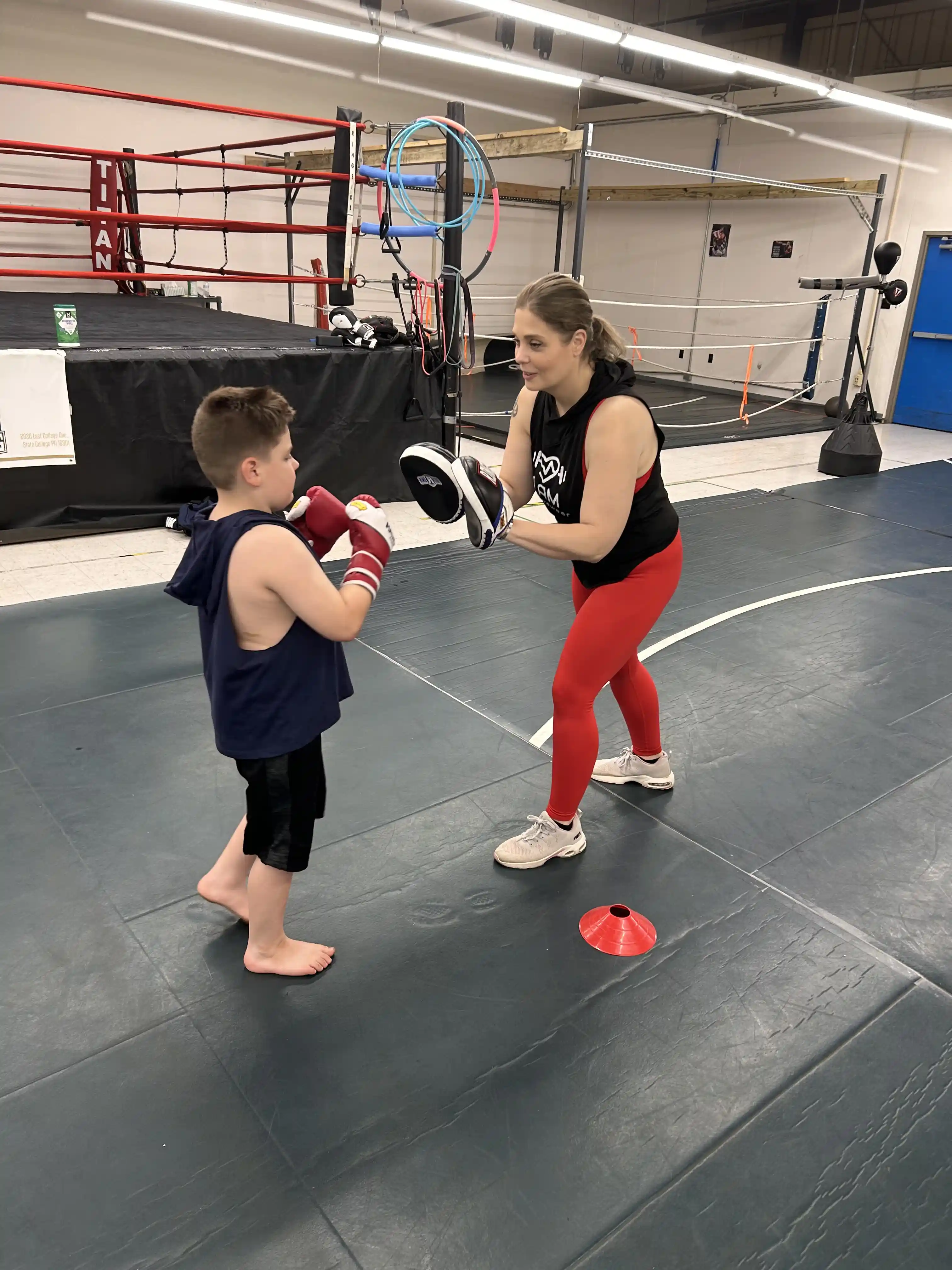 Class photo of the Legacy Boxing for kids class with a women coach