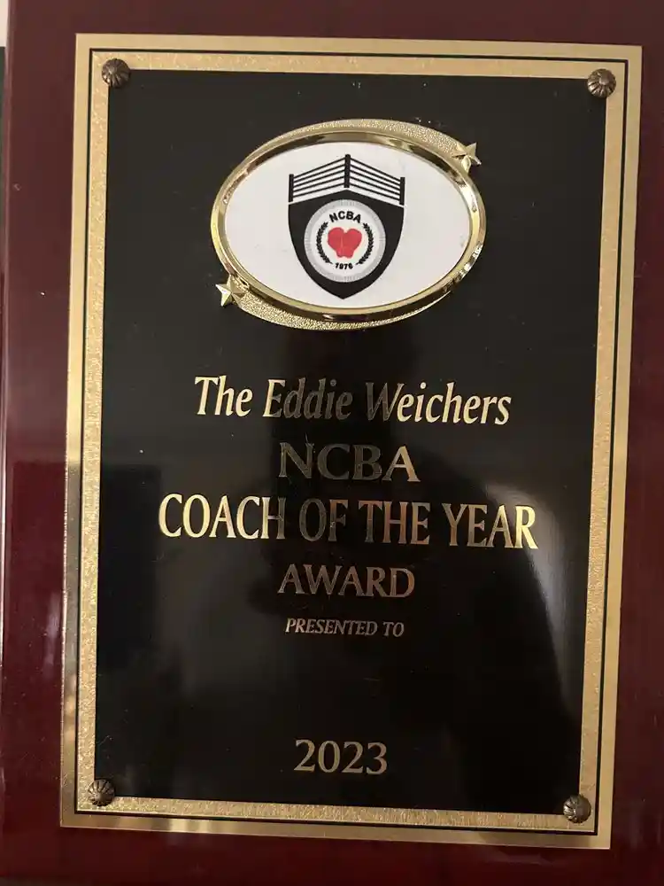 Coach Derek Roth receiving the 2023 NCBA Coach of the Year award