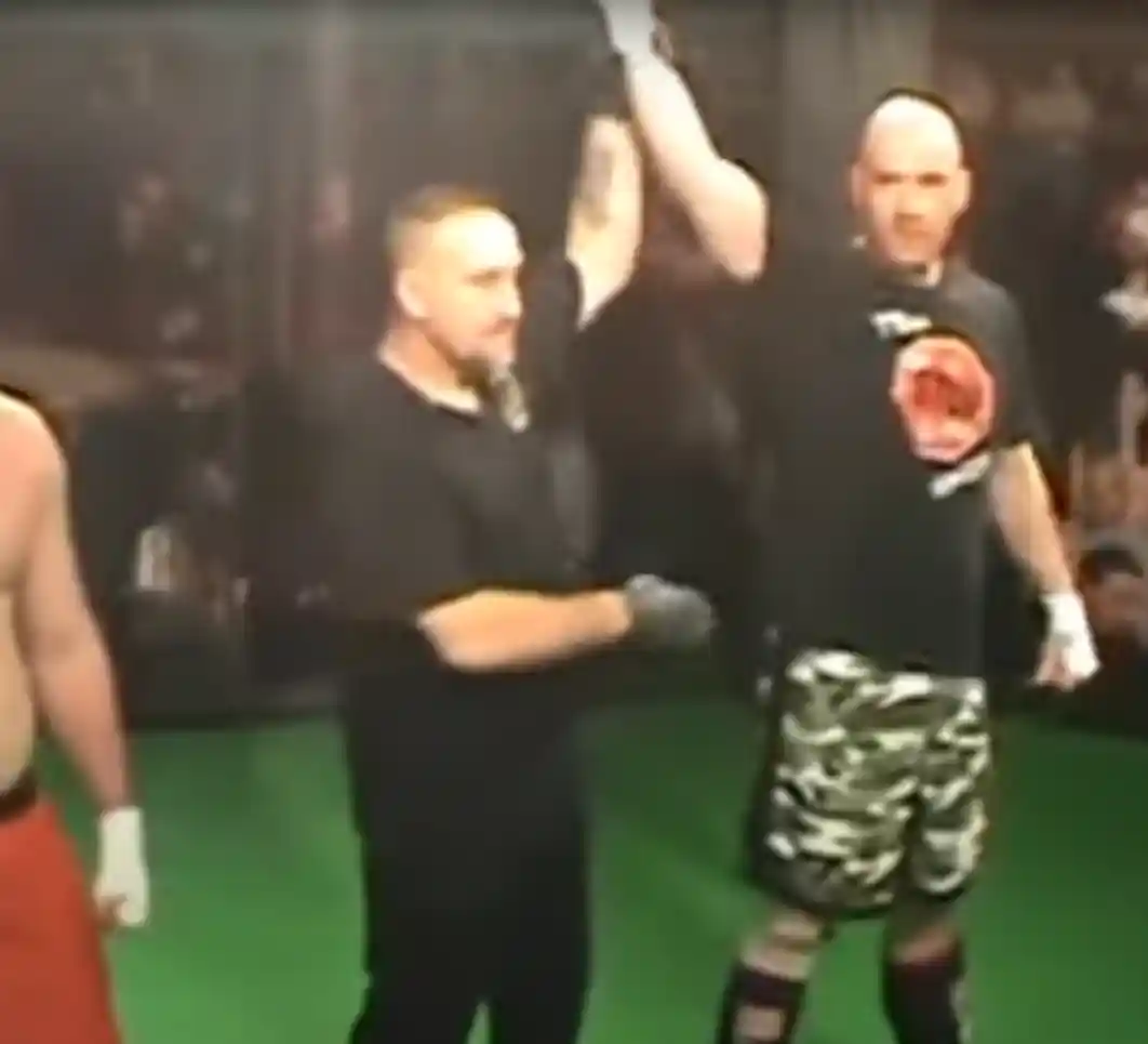 Coach Derek Roth winning an MMA cage fight
