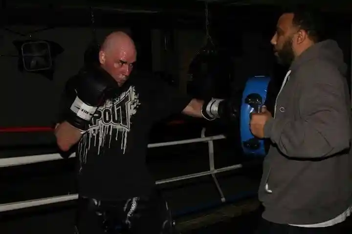 Young Coach Derek Roth training with a body pad